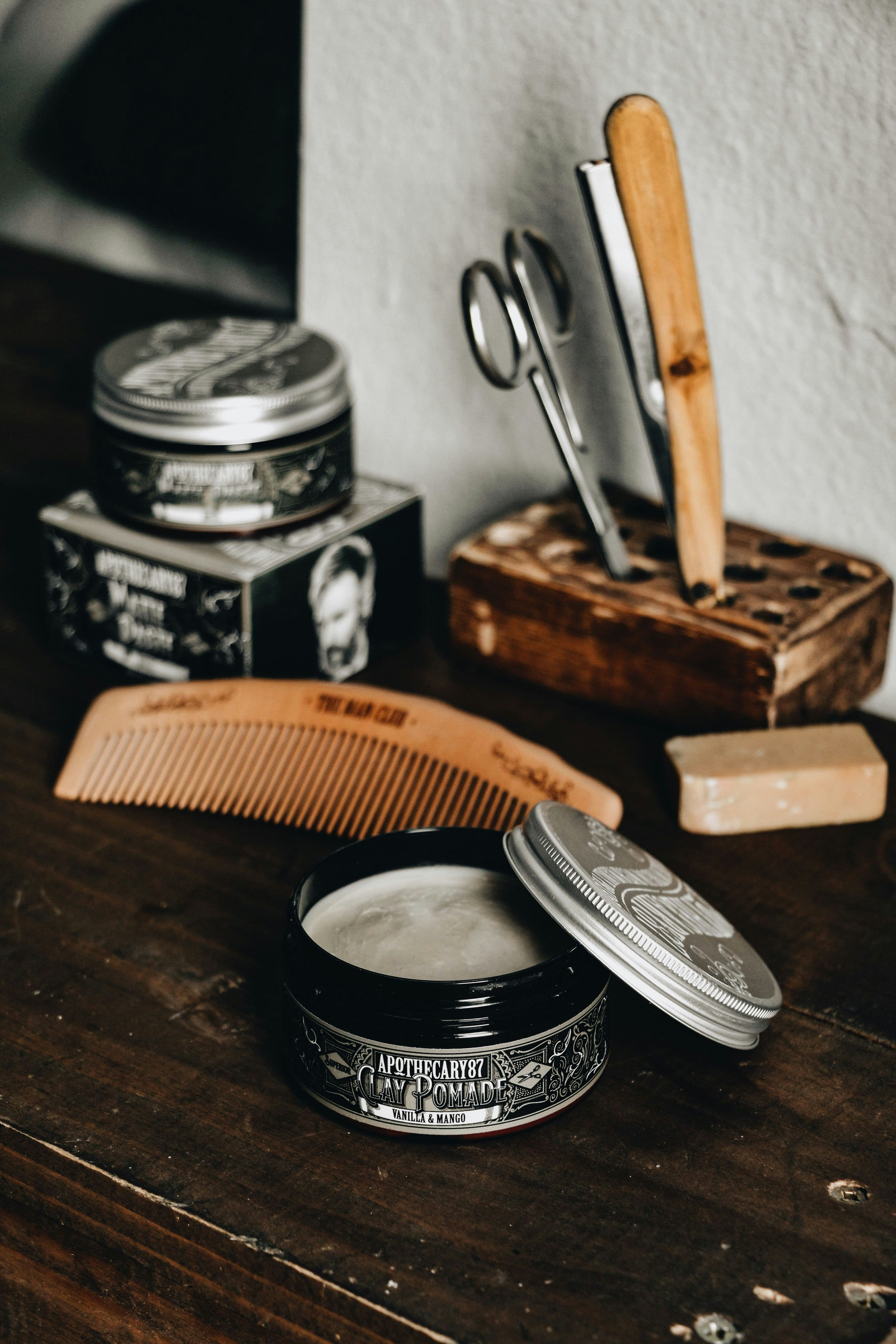 Premium grooming products and barber tools arranged on a wooden surface